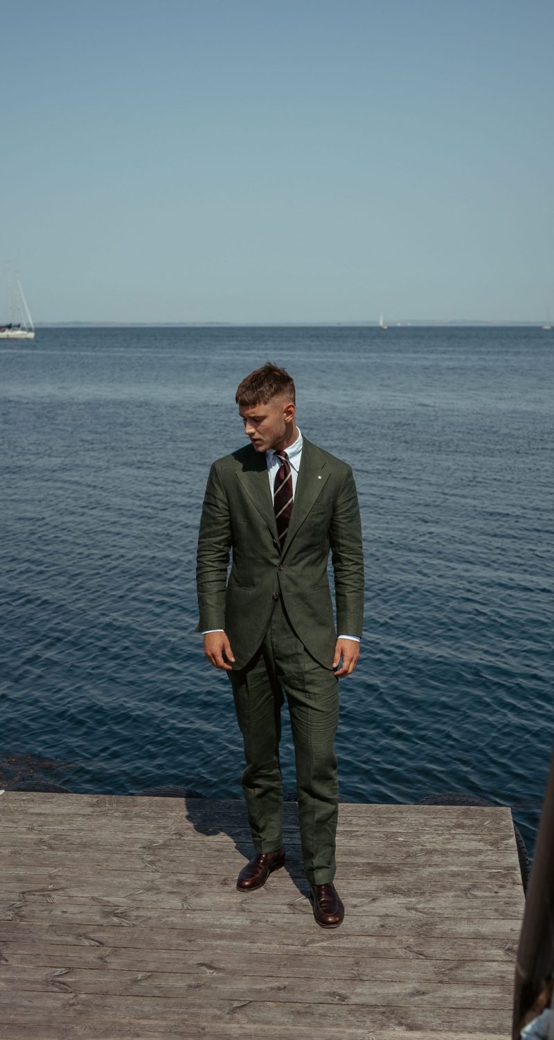 custom made green linen suit dockside, with striped maroon tie