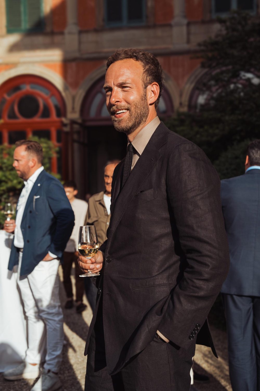 Andreas Weinas wearing a black linen suit at the Plaza Uomo party during Pitti Uomo, picture by mond