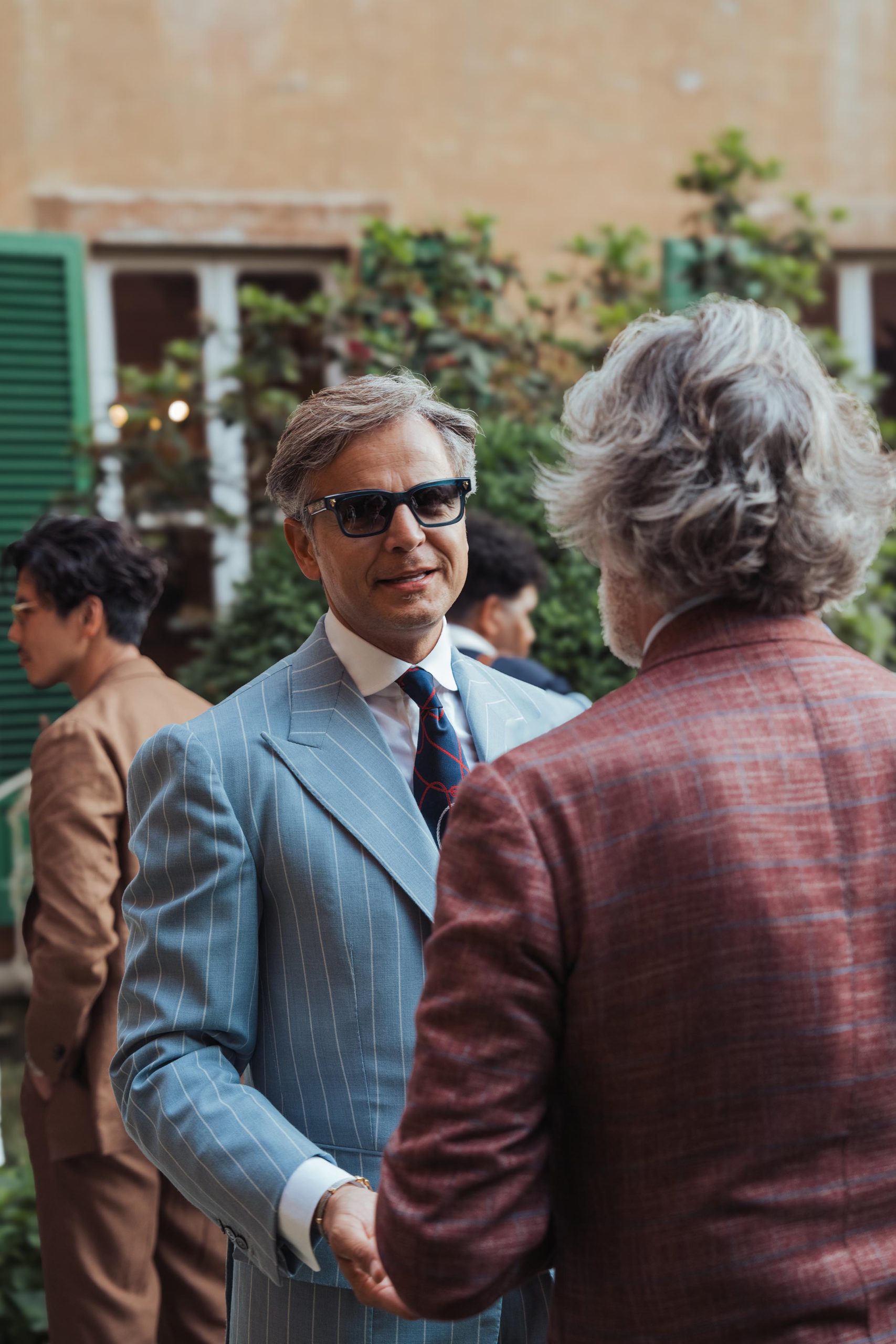 Mr. Mararo wearing a light blue striped suit at the plaza uomo party during pitti uomo 106