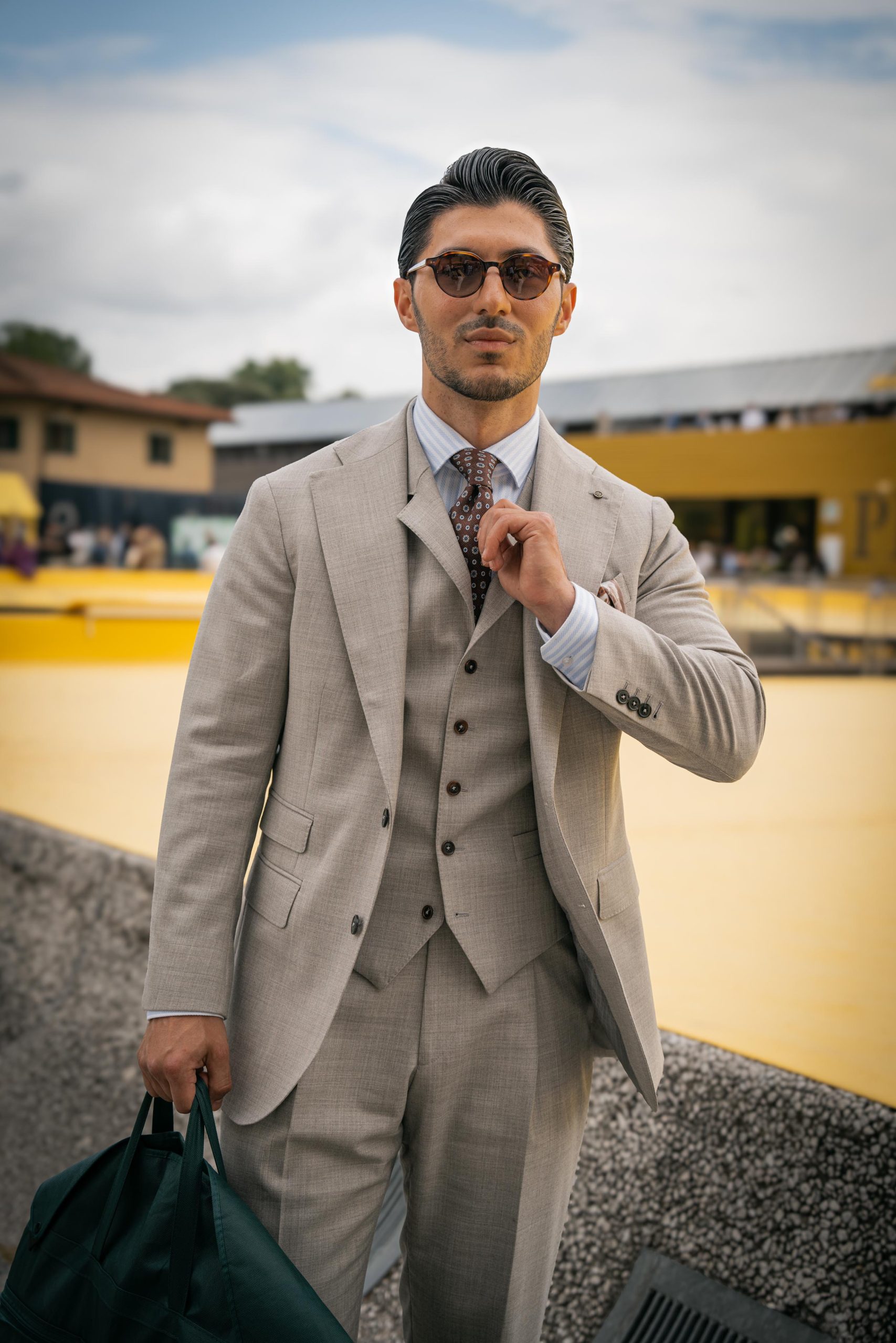 Okan dergentleman spotted at Pitti Uomo wearing a grey Mond suit.