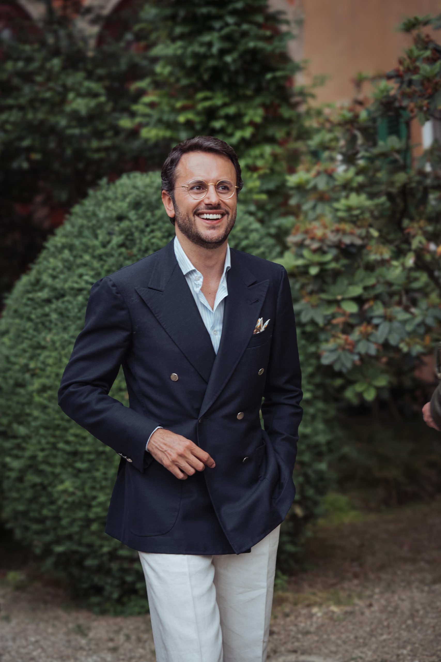 fabio attanasio wearing a navy blazer and white trousers at the plaza uomo party during pitti uomo 106