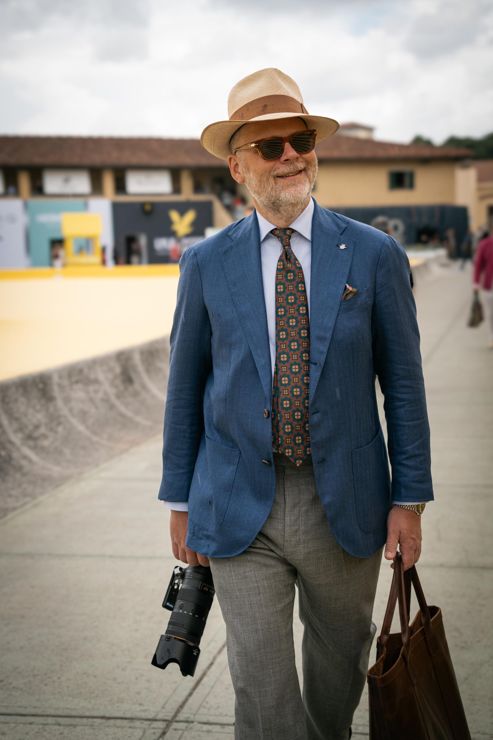 street style in Florence, Pitti Uomo, a gentleman wearing a blue jacket and grey trousers