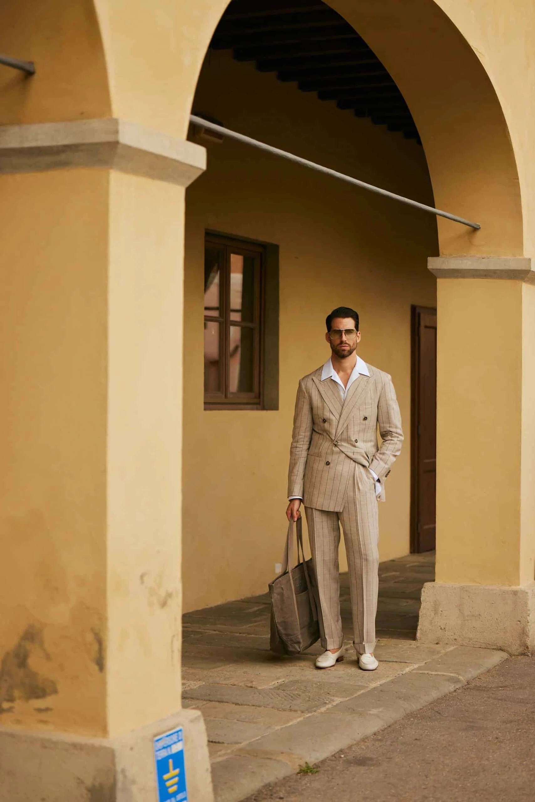 carlos domord at pitti uomo 104 wearing a beige striped suit and a linen camp collar shirt by mond of copenhagen