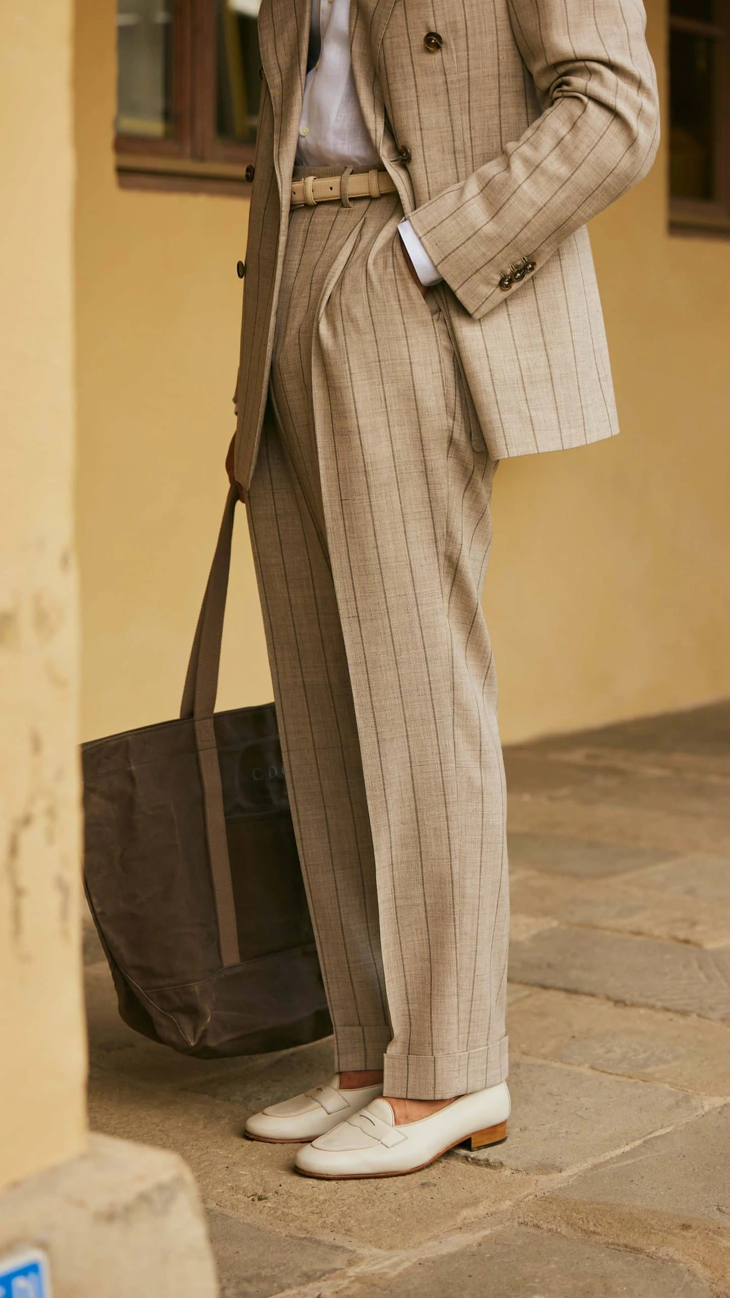 carlos domord at pitti uomo wearing taupe beige striped suit and a linen camp collar shirt by mond