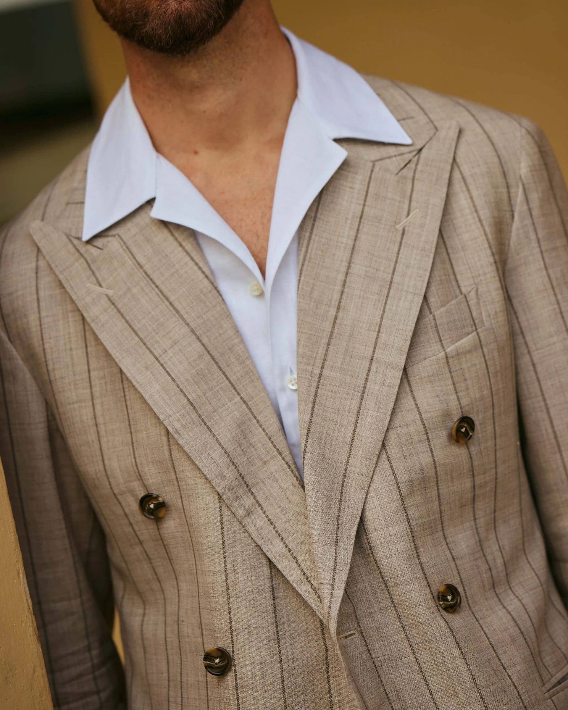 carlos domord at pitti uomo wearing taupe beige striped suit and a linen camp collar shirt