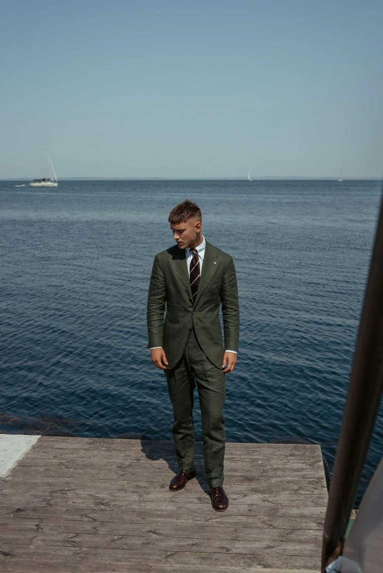 custom made green linen suit dockside, with striped maroon tie