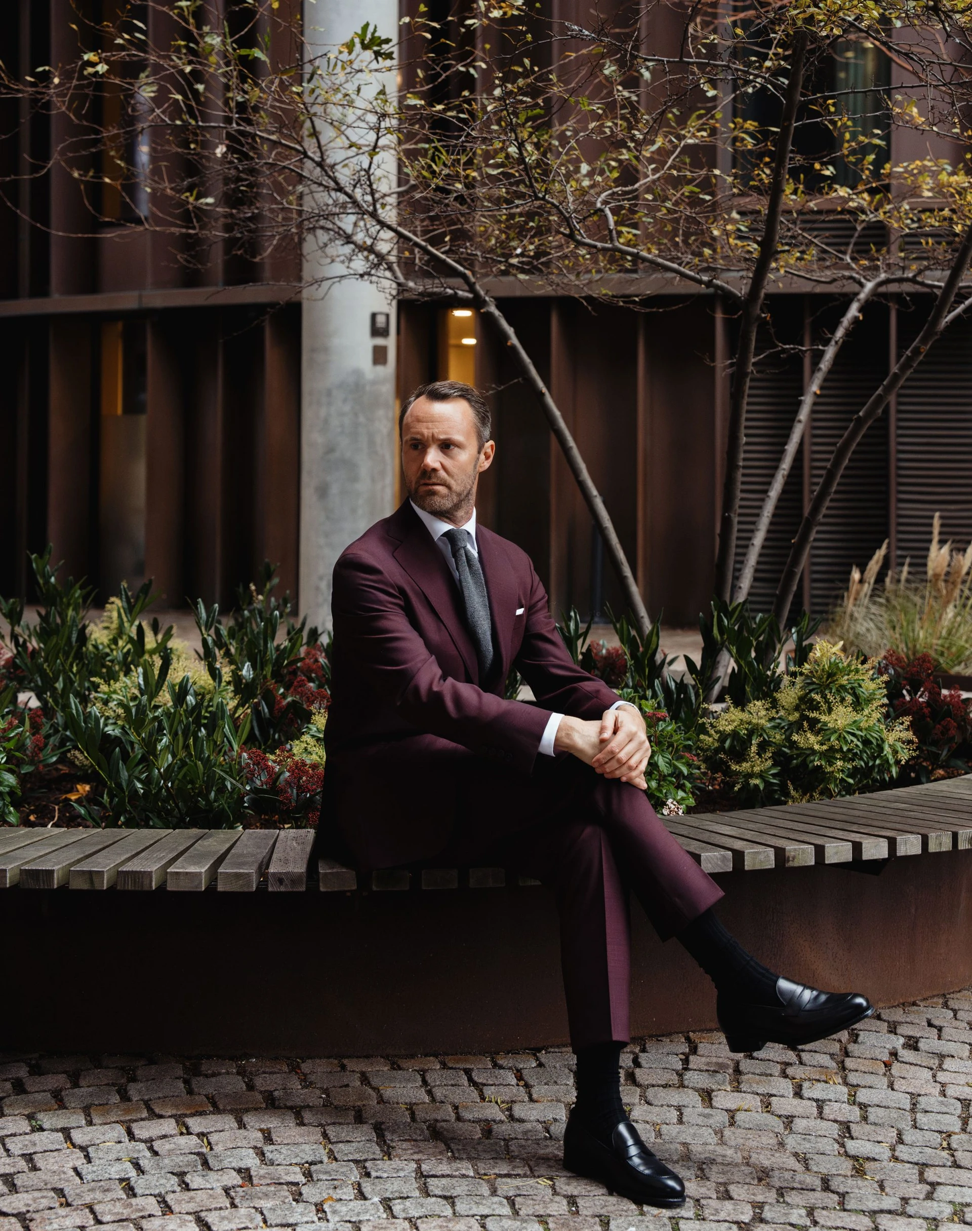 Man sitting in a maroon suit in twistair fabric