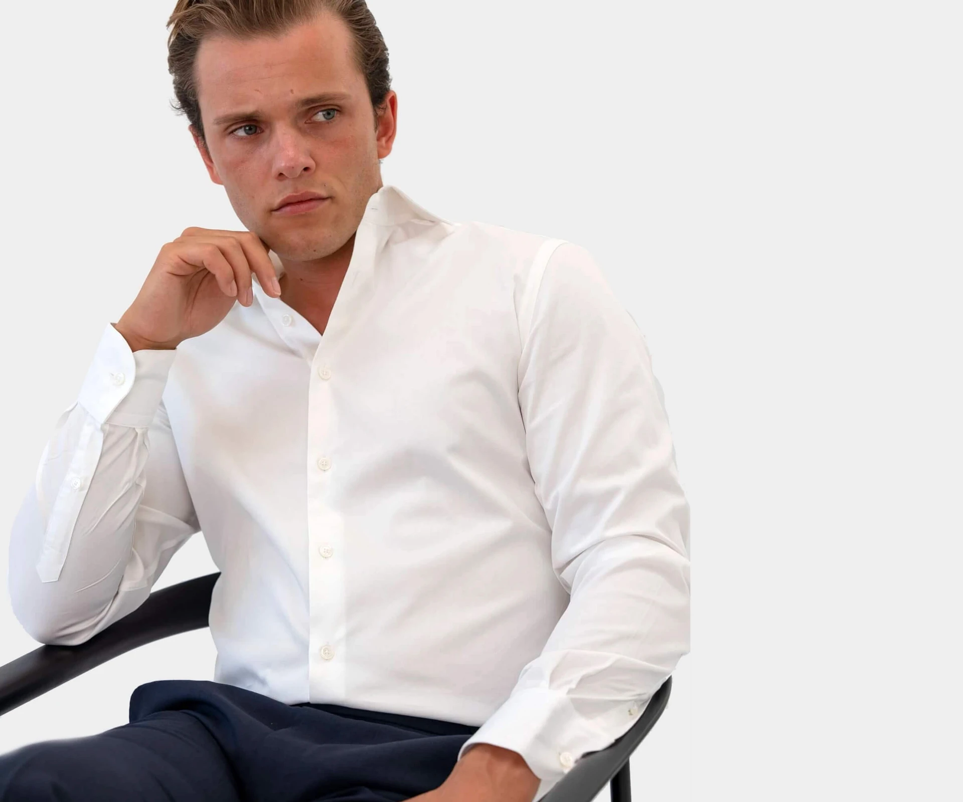 Man sitting in a tailored white shirt
