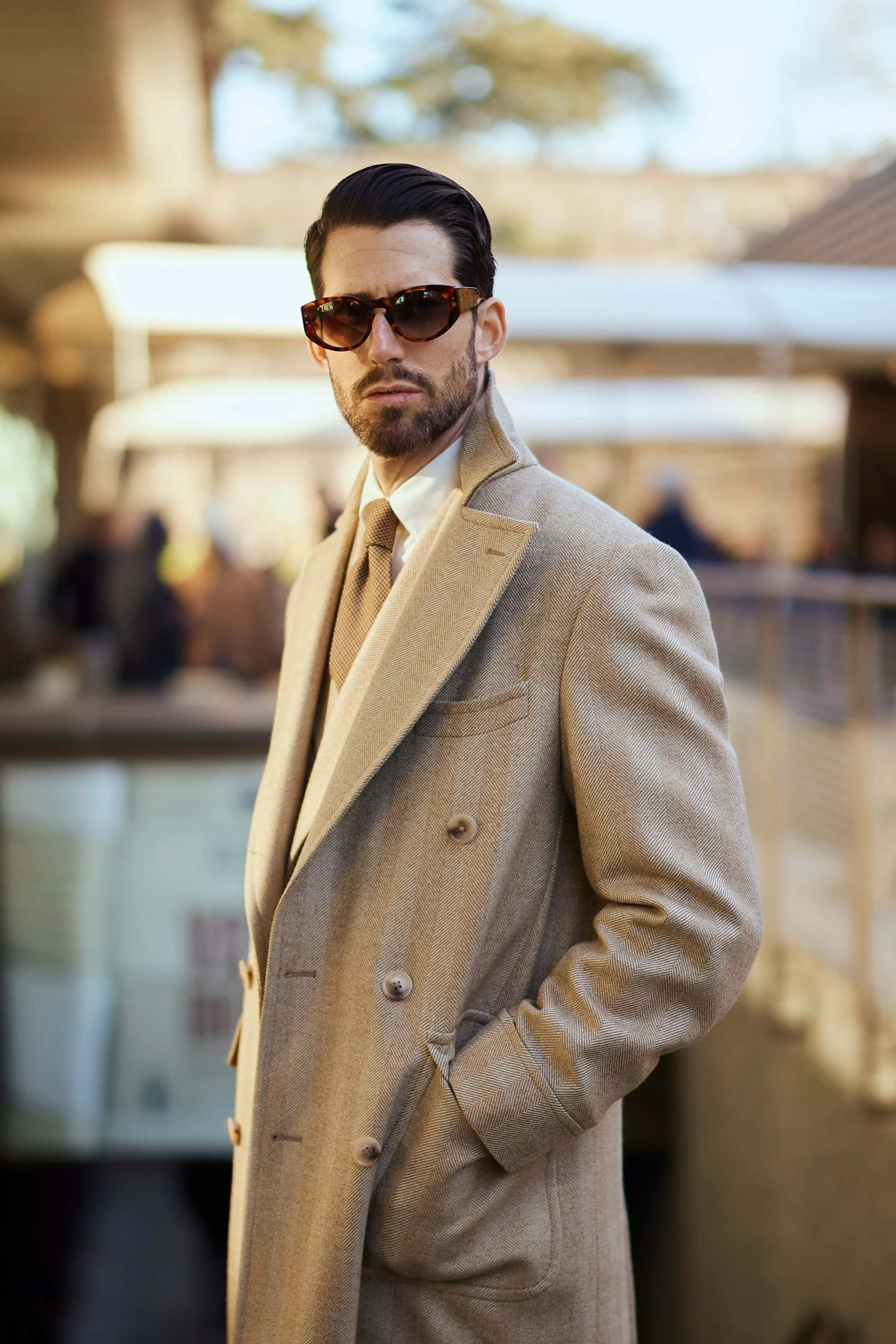 carlos domord at pitti uomo wearing a custom made beige herringbone coat and a matching suit from mond